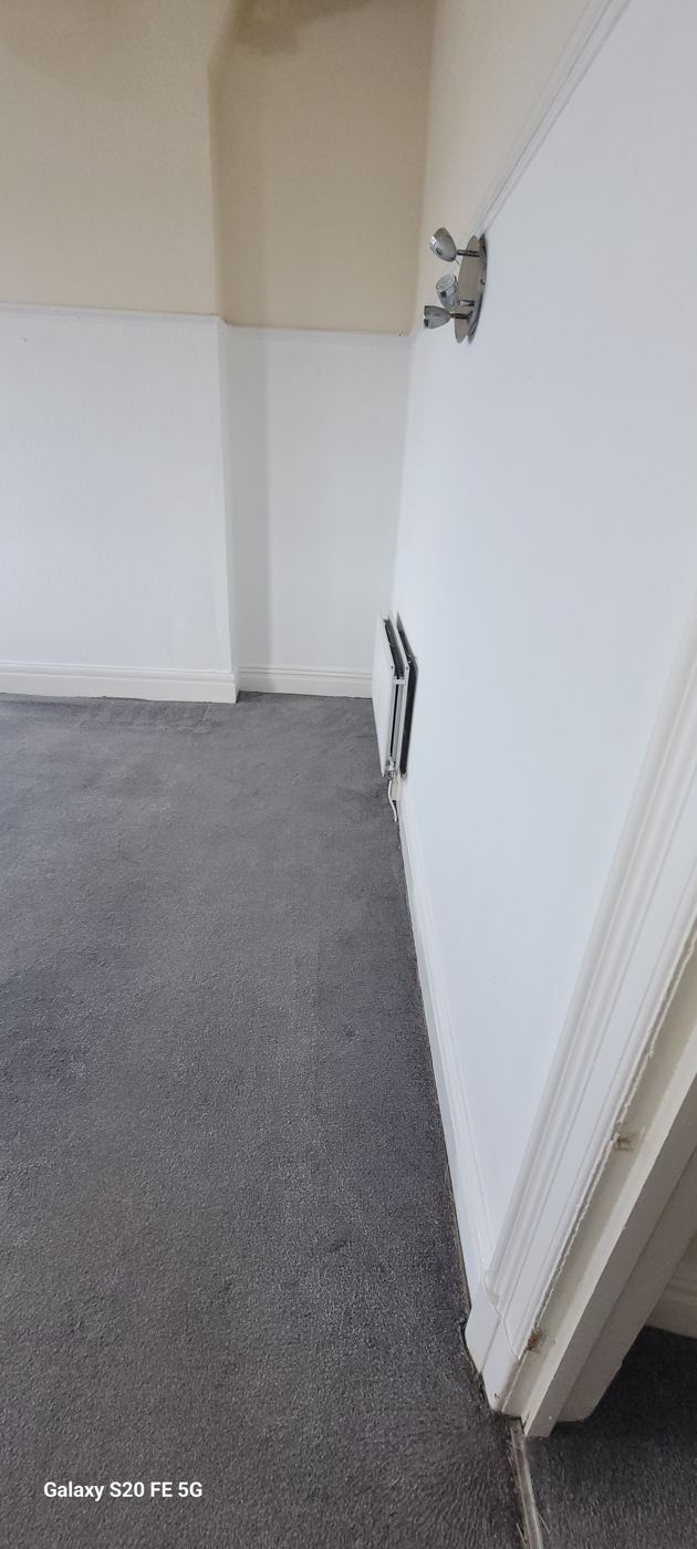 The same bedroom carpet cleaned, the debris and dust gone and the room ready to use