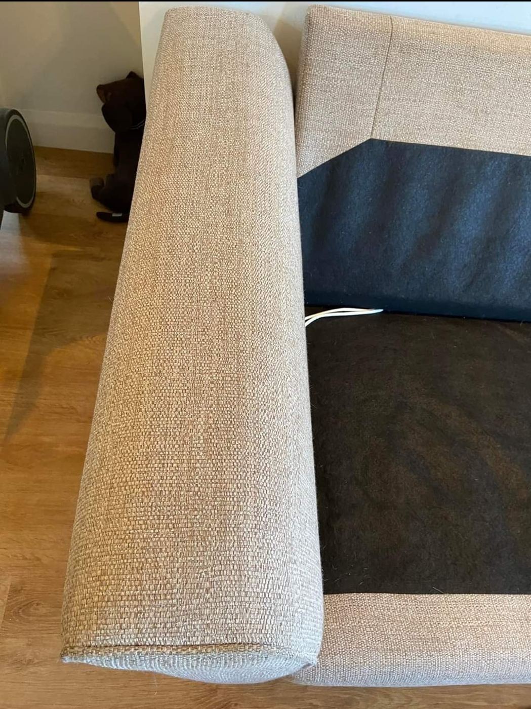 The same sofa arm after cleaning, the fabric back to an even oatmeal colour