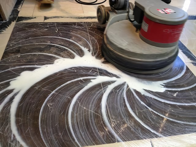 Rotary machine polishing a marble floor with diamond pads